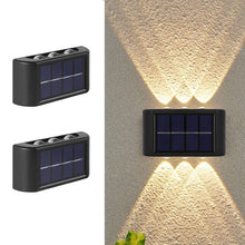 Cargar imagen en el visor de la galería, aplique bidireccional solar con 3 luces led calidas de 2w cada una sobre fondo blanco y encendido haz de luz